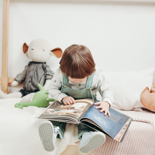 child-in-white-long-sleeve-top-and-dungaree-trousers-sitting-3661366